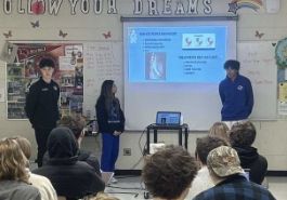  three students present group project to class