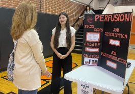  student presents career to event attendee