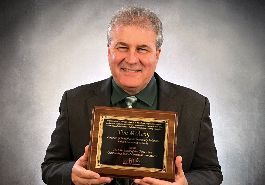  Tim McAvoy holds award plaque